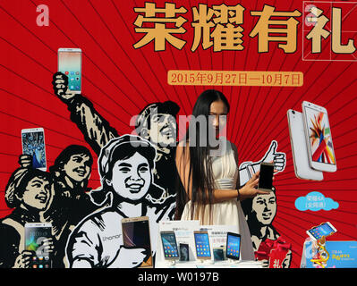 Chinese models promote various smartphones and laptops outside an electronics center notorious for selling fake, grey market and pirated electronics in Beijing on September 27, 2015.  The theft of intellectual property rights and corporate secrets from U.S. companies by China remains a major issue between the two countries.     Photo by Stephen Shaver/UPI Stock Photo