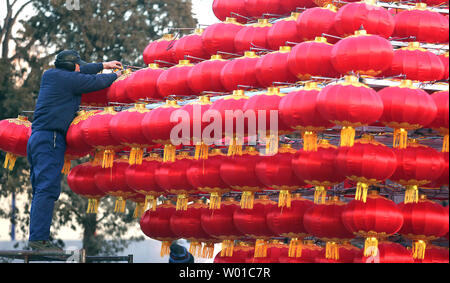 Chinese workers set-up a Chinese New Year's display of red lanterns prior ahead the start of its New Year  in Beijing on January 22, 2017. This year's Chinese New Year - The Year of the Rooster - begins January 28 and lasts about two weeks.   Also known as the Spring Festival, it is one of China's most important  holidays which sees millions of Chinese traveling home with gifts  for their families.    Photo by Stephen Shaver/UPI Stock Photo