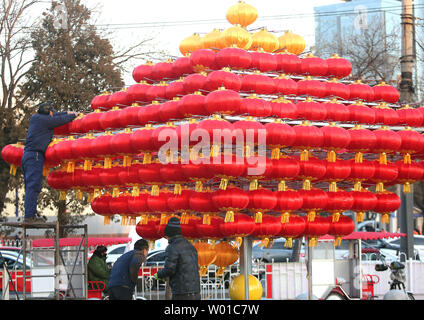 Chinese workers set-up a Chinese New Year's display of red lanterns prior ahead the start of its New Year  in Beijing on January 22, 2017. This year's Chinese New Year - The Year of the Rooster - begins January 28 and lasts about two weeks.   Also known as the Spring Festival, it is one of China's most important  holidays which sees millions of Chinese traveling home with gifts  for their families.    Photo by Stephen Shaver/UPI Stock Photo