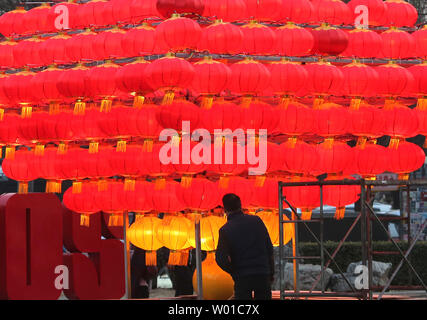 Chinese workers set-up a Chinese New Year's display of red lanterns prior ahead the start of its New Year  in Beijing on January 22, 2017. This year's Chinese New Year - The Year of the Rooster - begins January 28 and lasts about two weeks.   Also known as the Spring Festival, it is one of China's most important  holidays which sees millions of Chinese traveling home with gifts  for their families.    Photo by Stephen Shaver/UPI Stock Photo