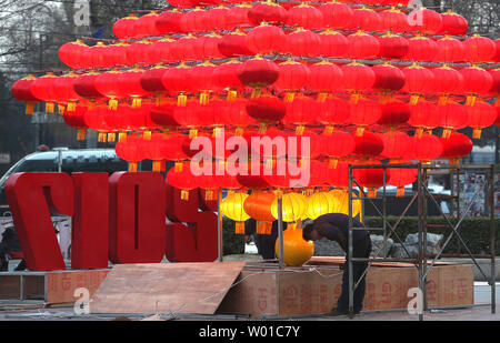 Chinese workers set-up a Chinese New Year's display of red lanterns prior ahead the start of its New Year  in Beijing on January 22, 2017. This year's Chinese New Year - The Year of the Rooster - begins January 28 and lasts about two weeks.   Also known as the Spring Festival, it is one of China's most important  holidays which sees millions of Chinese traveling home with gifts  for their families.    Photo by Stephen Shaver/UPI Stock Photo