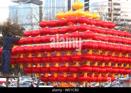 Chinese workers set-up a Chinese New Year's display of red lanterns prior ahead the start of its New Year  in Beijing on January 22, 2017. This year's Chinese New Year - The Year of the Rooster - begins January 28 and lasts about two weeks.   Also known as the Spring Festival, it is one of China's most important  holidays which sees millions of Chinese traveling home with gifts  for their families.    Photo by Stephen Shaver/UPI Stock Photo