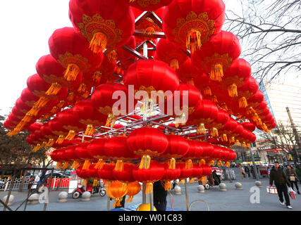 Chinese workers set-up a Chinese New Year's display of red lanterns prior ahead the start of its New Year  in Beijing on January 22, 2017. This year's Chinese New Year - The Year of the Rooster - begins January 28 and lasts about two weeks.   Also known as the Spring Festival, it is one of China's most important  holidays which sees millions of Chinese traveling home with gifts  for their families.    Photo by Stephen Shaver/UPI Stock Photo
