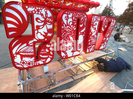 Chinese workers set-up a Chinese New Year's display of red lanterns prior ahead the start of its New Year  in Beijing on January 22, 2017. This year's Chinese New Year - The Year of the Rooster - begins January 28 and lasts about two weeks.   Also known as the Spring Festival, it is one of China's most important  holidays which sees millions of Chinese traveling home with gifts  for their families.    Photo by Stephen Shaver/UPI Stock Photo