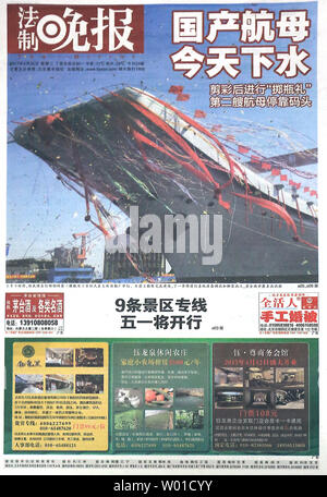 A major Chinese daily, heralding the launch of China's first domestically-built aircraft carrier in a front page story, is sold in Beijing on April 26, 2017.  The as-yet unnamed carrier is Chin'a second.     Photo by Stephen Shaver/UPI Stock Photo