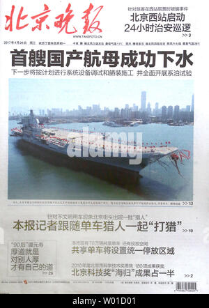 A major Chinese daily, heralding the launch of China's first domestically-built aircraft carrier in a front page story, is sold in Beijing on April 26, 2017.  The as-yet unnamed carrier is Chin'a second.     Photo by Stephen Shaver/UPI Stock Photo