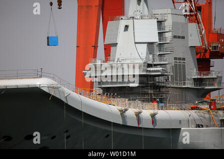 China's first domestically built aircraft carrier, officially launched last month, remains parked in the shipyard where it was built in the port city Dalian, one of China's major ports, in Liaoning Province on May 6, 2017.  The carrier is not ready for operation, but it was hailed as a naval milestone in President Xi Jinping's drive to extend China's military reach far beyond its shores.     Photo by Stephen Shaver/UPI Stock Photo