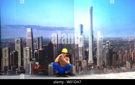 A Chinese construction worker takes a break outside a commercial building site in downtown Beijing on August 26, 2017.  Construction growth in China, the world's second largest economy, is forecasted to slump to historical lows in the short term, with no recovery expected until 2030.  China is one of the main drivers of construction globally, followed by the U.S. and India.    Photo by Stephen Shaver/UPI Stock Photo
