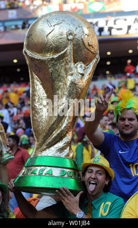 Brazil fans pose with a giant replica of the World Cup prior to the FIFA World Cup Quarter Final match at the Nelson Mandela Bay Stadium in Port Elizabeth, South Africa on July 2, 2010. The Netherlands beat Brazil 2-1. UPI/Chris Brunskill Stock Photo