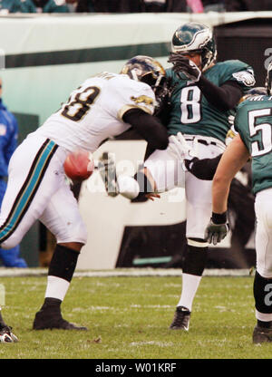 Jacksonville Jaguars' Brian Iwuh (59) and Jorge Cordova (58) pummel  Philadelphia Eagles punter Dirk Johnson after he punted the ball at Lincoln  Financial Field in Philadelphia, Pennsylvania, Sunday, October 29, 2006. The