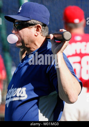 Los Angeles Dodgers third base coach and former Philadelphia Manager Larry Bowa relaxes with bubble gum and a bat during batting practice prior to their second NLCS game with the Philadelphia Phillies in Philadelphia at Citizens Bank Park October 10, 2008.  (UPI Photo/John Anderson) Stock Photo