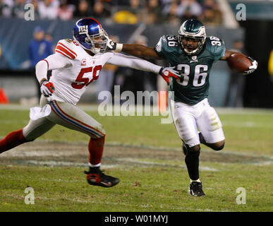 Philadelphia Eagles Brian Westbrook (36) keeps New York Giants linebacker Antonio Pierce (58) at arm's length as he runs for a 9-yard gain during second quarter play in Philadelphia at Lincoln Financial Field November 9, 2008.     (UPI Photo/John Anderson) Stock Photo