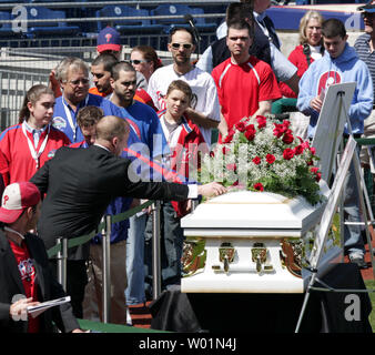 One of the many thousands of fans who came to Citizens Bank Park April 18, 2009 to pay their respects Hall of Famer Philadelphia Phillies announcer Harry Kalas passes a rose on the casket as he passes by. Kalas,  A Philadelphia Phillies announcer for the past 30 years, Kalas died earlier this week at a game.  He is only the second baseball person to lie in state in a professional baseball stadium since Babe Ruth in 1948.   (UPI Photo/John Anderson) Stock Photo
