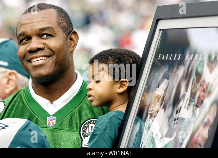 Philadelphia Eagles former quarterback Randall Cunningham holds his young  son, Christian as he is inducted into the Eagles Honor Roll during half  time ceremonies in Philadelphia at Lincoln Financial Field September 27,