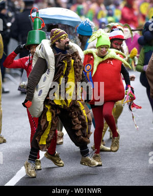 Mummers belonging to one of the comic divisions dance their way up Broad Street in downtown Philadelphia January 1, 2010. Thousands dress up in comic costumes and feathered outfits to participate in the parade that has been a Philadelphia tradition for 110 years.     UPI/John Anderson Stock Photo