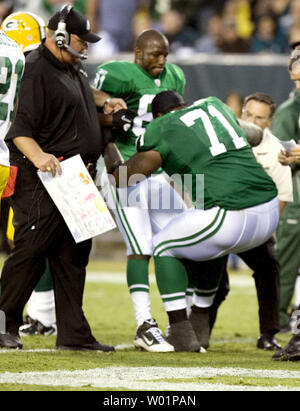 Philadelphia Eagles quarterback Michael Vick gains yardage as dodges around  tackle Todd Herremans who takes down Green Bay Packers B. J. Raji (90)  during fourth quarter Philadelphia Eagles-Green Bay Packers game action