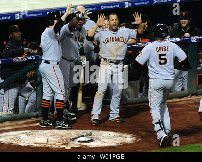 San Francisco Giants' Juan Uribe (5) is congratulated by teammates after connecting for a solo homerun during the 8th inning against the Philadelphia Phillies in game 6 of the NLCS at Citizens Bank Park in Philadelphia on October 24, 2010. The Giants defeated the Phillies 3-2 winning the NLCS 4 games to 2.  UPI/Kevin Dietsch. Stock Photo