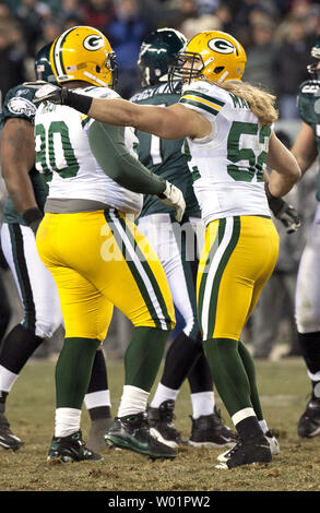 Philadelphia Eagles quarterback Michael Vick gains yardage as dodges around  tackle Todd Herremans who takes down Green Bay Packers B. J. Raji (90)  during fourth quarter Philadelphia Eagles-Green Bay Packers game action