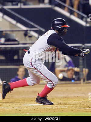 PHO2001050906 - 09 MAY 2001 - PHOENIX, ARIZONA, USA: Former Dallas Cowboy  football standout and current Cincinnati Red left fielder Neon Deion  Sanders, misses a bunt in the 8th inning of the