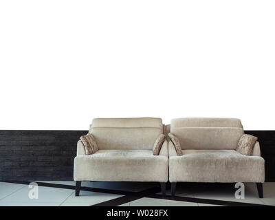 Twin grey velvet sofa bed on black brick and white wall background with copy space. Stock Photo