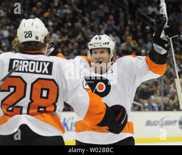 Philadelphia Flyers' Claude Giroux celebrates his 2nd period goal with  teammates Andrej Meszaros (center) and Braydon Colburn during the 2nd  period of the 2012 Winter Classic at Citizens Bank Park in Philadelphia