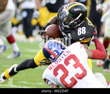 New York Giants cornerback Corey Webster (23) pulls down Pittsburgh Steelers wide receiver Emmanuel Sanders (88) following his nine yard  reception in the first quarter of the preseason game at Heinz Field in Pittsburgh on August 10, 2013.  UPI/Archie Carpenter Stock Photo