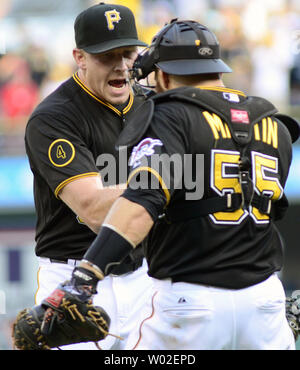 Pittsburgh Pirates' Russell Martin (55) gets a facefull of cream in  celebration from Pittsburgh Pirates' A.J. Burnett after Martin drove in  Gaby Sanchez with the game winning hit in the fourteenth inning