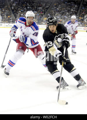 New York Rangers center Dominic Moore (28) closes in on Pittsburgh Penguins right wing Steve Downie (23) as he passes the puck in the second period of the New York Rangers 5-2 win over the Pittsburgh Penguins at the Consol Energy Center in Pittsburgh on January 18, 2015.  Photo by Archie Carpenter/UPI Stock Photo