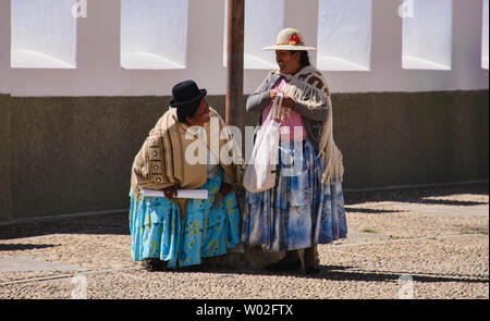 Cholitas at the Basílica de Nuestra Señora church in Copacabana, Bolivia Stock Photo