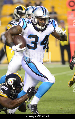 Carolina Panthers running back Cameron Artis-Payne (34) crosses the goal  line against New Orleans Saints cornerback Marshon Lattimore (23) on a  tcoudhown carry in the first half of an NFL football game