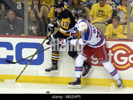 New York Rangers defenseman Brady Skjei (76) checks Pittsburgh Penguins center Nick Bonino (13) into the glass in the first period of game two of the first round of the Stanley Cup playoffs at the Consol Energy Center in Pittsburgh on April 16, 2016.  Photo by Archie Carpenter/UPI Stock Photo