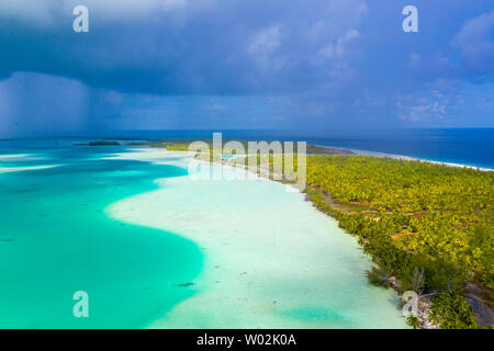 French Polynesia Tahiti aerial drone view of Fakarava atoll and famous Blue Lagoon and motu island with perfect beach, coral reef and Pacific Ocean. Tropical travel paradise in Tuamotus Islands. Stock Photo