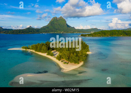 Bora Bora in French Polynesia. Aerial view of Motu Tapu paradise island and turquoise blue water in coral reef lagoon and Mt Pahia, Mount Otemanu, Tahiti, South Pacific Ocean. Stock Photo