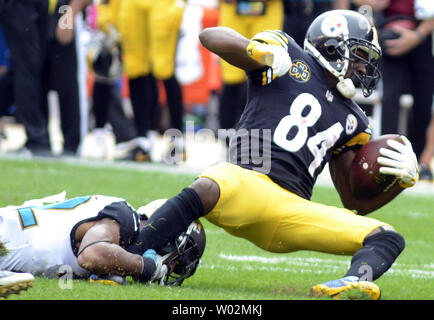 Jacksonville Jaguars cornerback Aaron Colvin (22) smiles as he runs off the  field following the Jaguars 30-9 win against the Pittsburgh Steelers at  Heinz Field in Pittsburgh on October 8, 2017. Photo