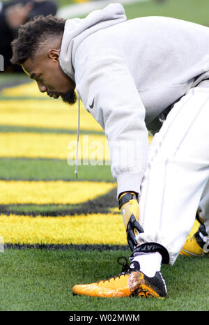 New England Patriots safety Rodney Harrison is dressed for the cold as he  stands on the stadium field as practice begins at the NFL football team's  facility in Foxborough, Mass., Thursday afternoon