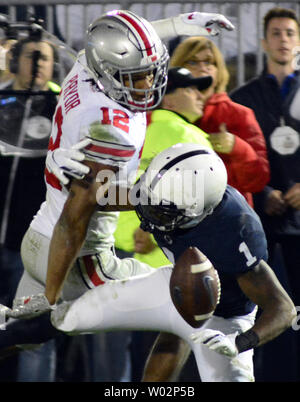 Ohio State Buckeyes safety Isaiah Pryor (12)  receives a defensive interference call as Penn State Nittany Lions wide receiver KJ Hamler (1) falls to the turf in the third quarter of the Ohio State Buckeyes 27-26 victory at Beaver Stadium in State College , Pennsylvania on September 29, 2018. Photo by Archie Carpenter/UPI Stock Photo