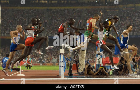 Runners fly over a hurdle, landing in a water hazard, during the opening lap of the Olympic men's 3000m steeplechase final in Beijing August 18, 2008. Kenya's Brimin Kiprop Kipruto won the gold medal in a time of 8:10.34, France's Mahiedine Mekhiss took the silver and the bronze went to Richard Kipkemboi Mateelong of Kenya.   (UPI Photo/Stephen Shaver) Stock Photo