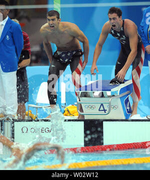 USA's Michael Phelps (L) and teammate Garrett Weber-Gale cheer on Jason Lezak at the finish of the Men's 4x100M Relay Final at the National Aquatics Center at the Summer Olympics in Beijing on August 11, 2008.  Lezak came from behind and won a dramatic victory for the United States team, setting a World Record time of 3:08.24.   (UPI Photo/Pat Benic)l Stock Photo