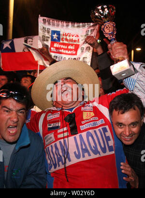 Town residents cheer after all 33 miners trapped in the nearby San Jose Mine were rescued near Copiapo, Chile on October 13, 2010.  An accident trapped 33 miners for more than two months more than 2,000 feet below the surface.    UPI/Sebastian Padilla Stock Photo