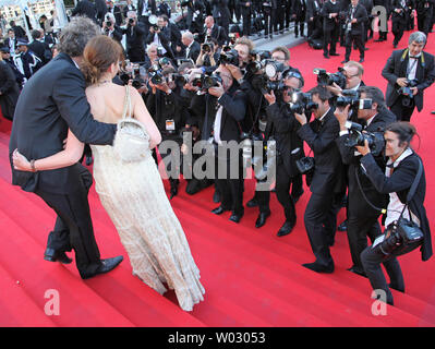 Stephane Guillon (R) and Muriel Cousin are photographed on the red-carpeted steps of the Palais des Festivals before the screening of the film 'Lawless' during the 65th annual Cannes International Film Festival in Cannes, France on May 19, 2012. UPI/David Silpa Stock Photo
