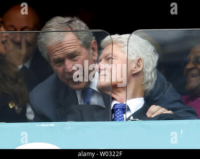 Former United States Presidents George Bush and Bill Clinton (R) are seen at the memorial service for former South African President and anti-apartheid leader Nelson Mandela at FNB Stadium in Johannesburg, South Africa, on December 10, 2013.  Nearly 100 heads of state and roughly 100,000 mourners attended the service for Mandela, who died last week at the age of 95.     UPI/Jemal Countess Stock Photo