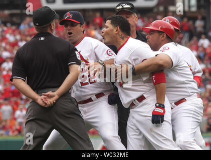 St. Louis Cardinals Yadier Molina is restrained by brother Bengie