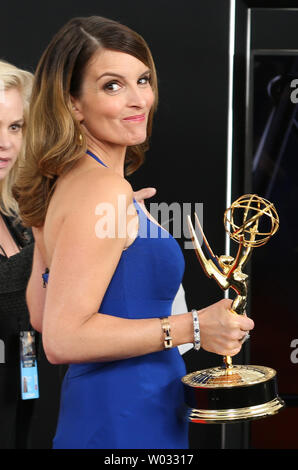 Actress/writer Tina Fey holds the award she won for  'Outstanding Writing for a Comedy Series - 30 Rock (Last Lunch) ' at the 65th Primetime Emmy Awards at Nokia Theatre in Los Angeles on September 22, 2013.   UPI/Danny Moloshok Stock Photo