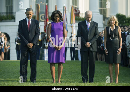 President Barack Obama (L), First Lady Michelle Obama, Vice President Joe Biden, Dr. Jill Biden and White House staff observe a moment of silence for the 12 anniversary of the 9/11 terrorist attacks, at the White House  in Washington, D.C. on September 11, 2013.  UPI/Kevin Dietsch Stock Photo