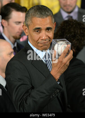 President Obama holds a Giants baseball
