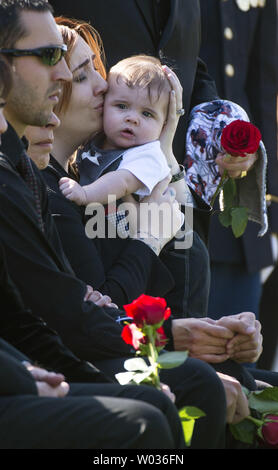 Alexandra McClintock, the widow of U.S. Army Sgt. First Class Matthew Q. McClintock, holds their son Declan during his funeral at Arlington National Cemetery in Arlington, Virginia, on March 7, 2015. SFC McClintock, a U.S. Army Special Forces soldier, was killed in action on Tuesday, January 5, 2016, in Afghanistan. Photo by Kevin Dietsch/UPI Stock Photo