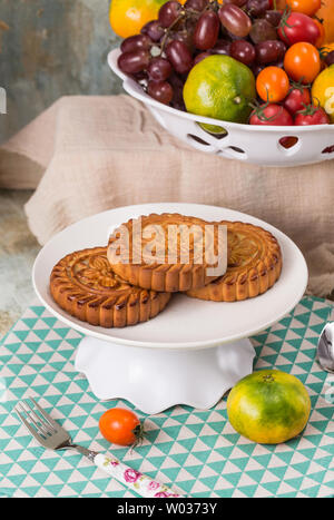 Moon cakes and fruit on the table Stock Photo