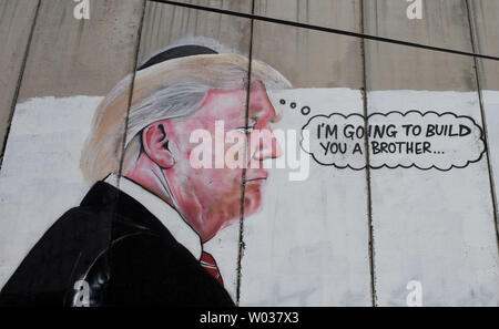 Graffiti of U.S. President Donald Trump is seen on Israel's controversial separation wall in the biblical city of Bethlehem, West Bank, on August 9, 2017. The graffiti depicts Trump wearing a Jewish skullcap and thinking 'I'm going to build you a brother' in reference to the wall he has promised to build on the Mexican border. Photo by Debbie Hill/UPI Stock Photo