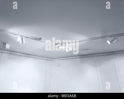 exhibition ceiling with fluorescent spotlights near empty wall Stock Photo