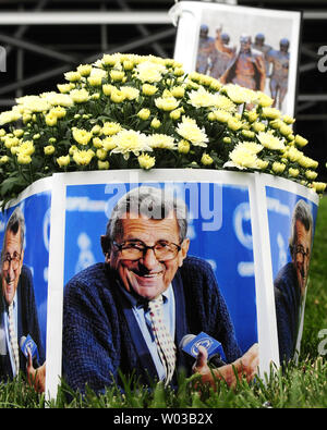 One the site where the statue of  former Penn State coach Joe Paterno stood,  fans leave flowers and photos of the late  coach following the 24-14 Penn State lost to Ohio at Beaver Stadium in University Park, PA on September 1, 2012.    UPI/Archie Carpenter Stock Photo